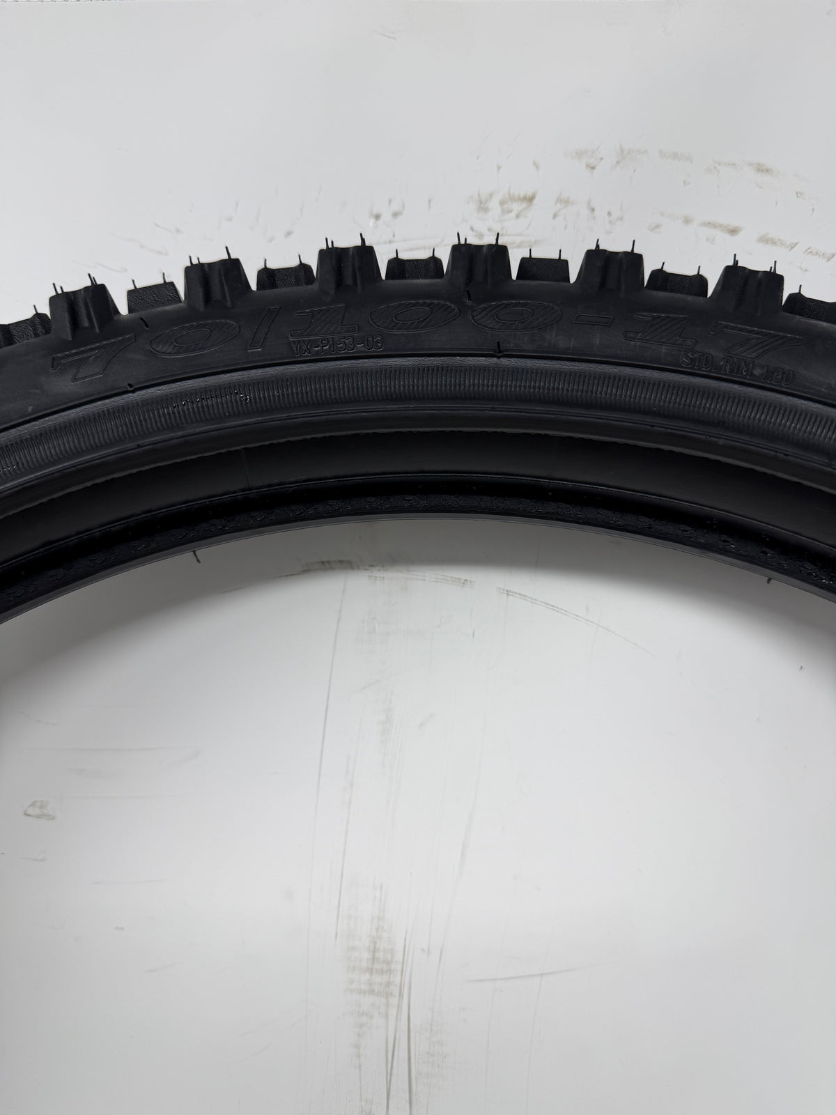 70/100-17 motorcycle tire, close-up of size and molded sidewall markings