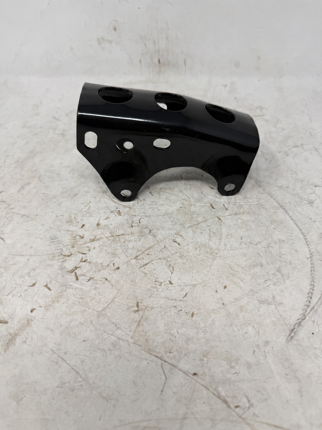 Sportster 250cc DF250RTG black under-engine fixing plate showing mounting holes and curved cutout, angled view