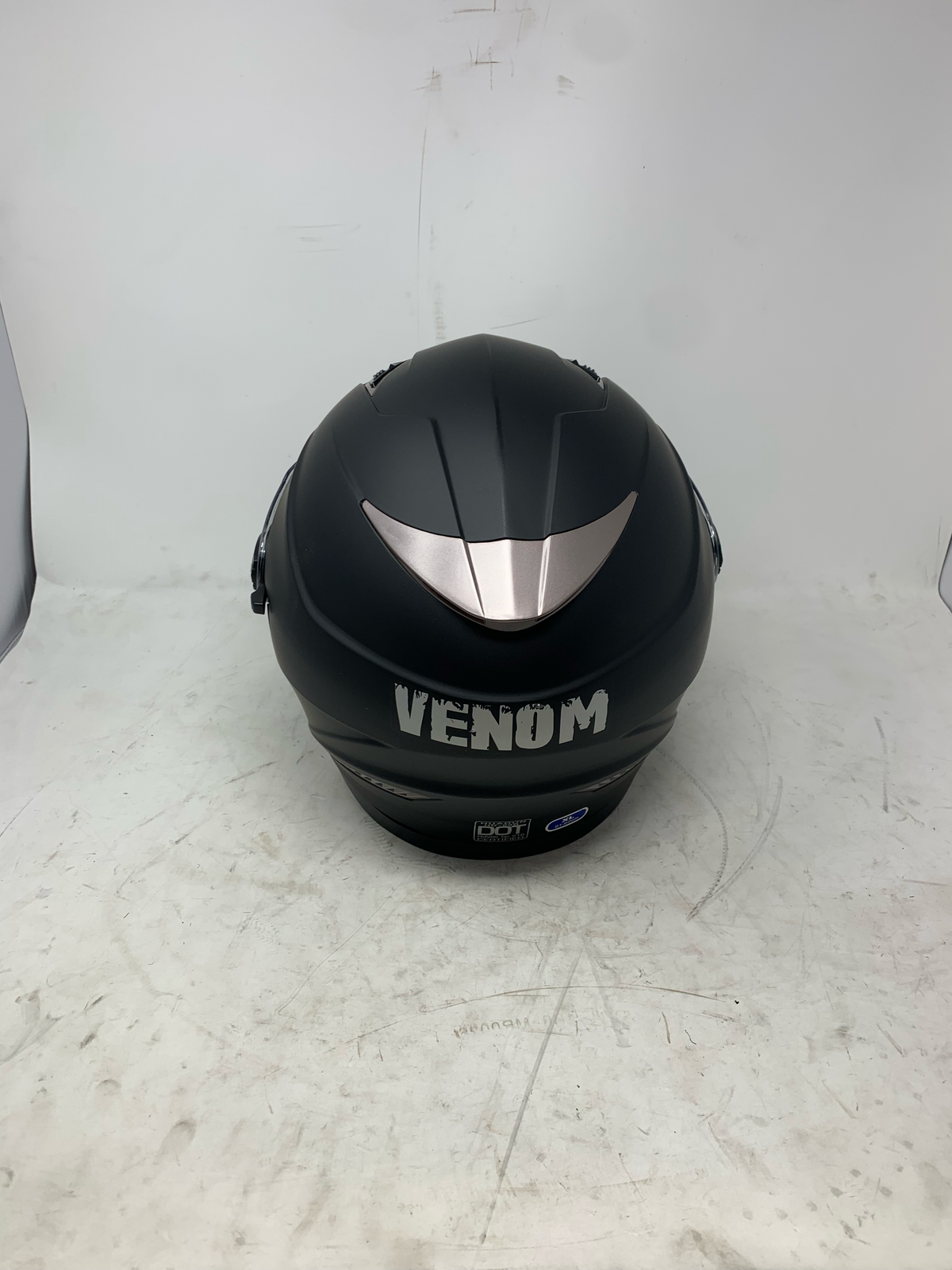 Black full face motorcycle helmet rear view with DOT certification and size label