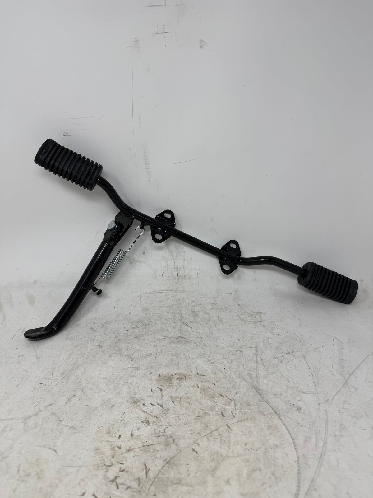 Alternate mounting view of the DF250RTG Sportster 250cc kickstand and spring; footrest bar and foot pegs shown are not included