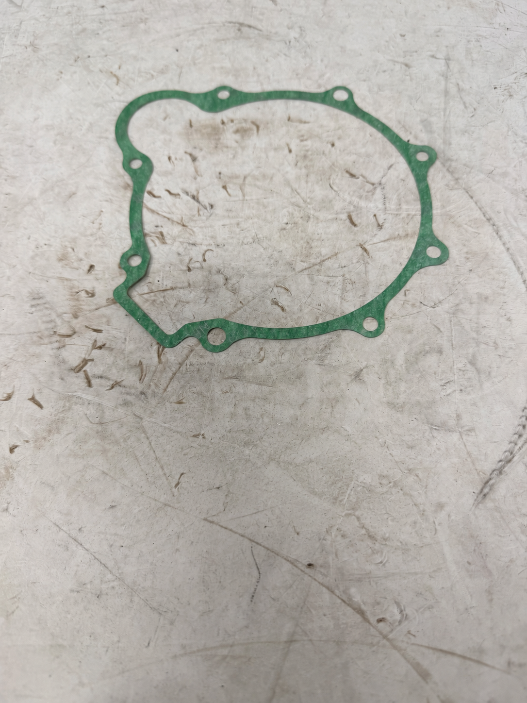 Green right crankcase cover gasket for DF250RTG Sportster 250cc motorcycle, showing sealing outline and bolt holes