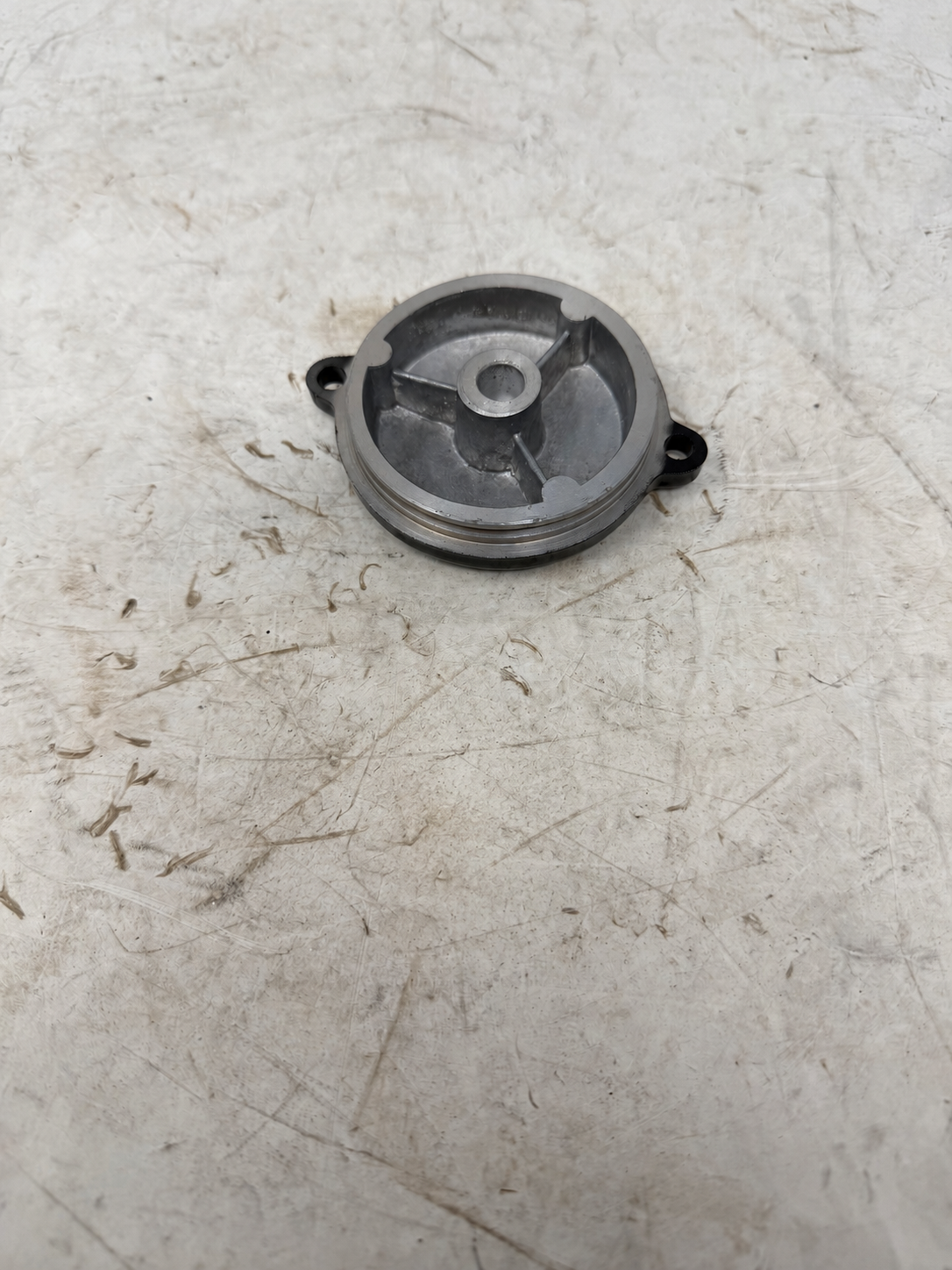 Inside view of black starter reduction gear cover for DF250RTG Sportster 250cc motorcycle, with mounting ears