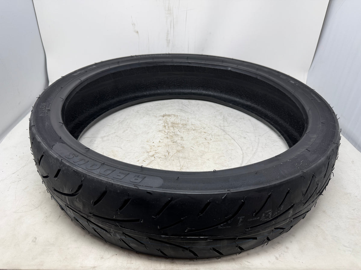 110/70-17 motorcycle tire, angled view showing tread pattern