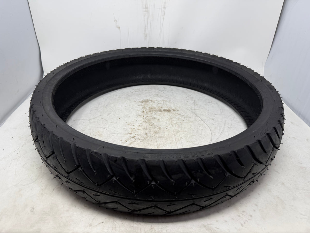 110/80-17 motorcycle tire, angled view showing tread pattern