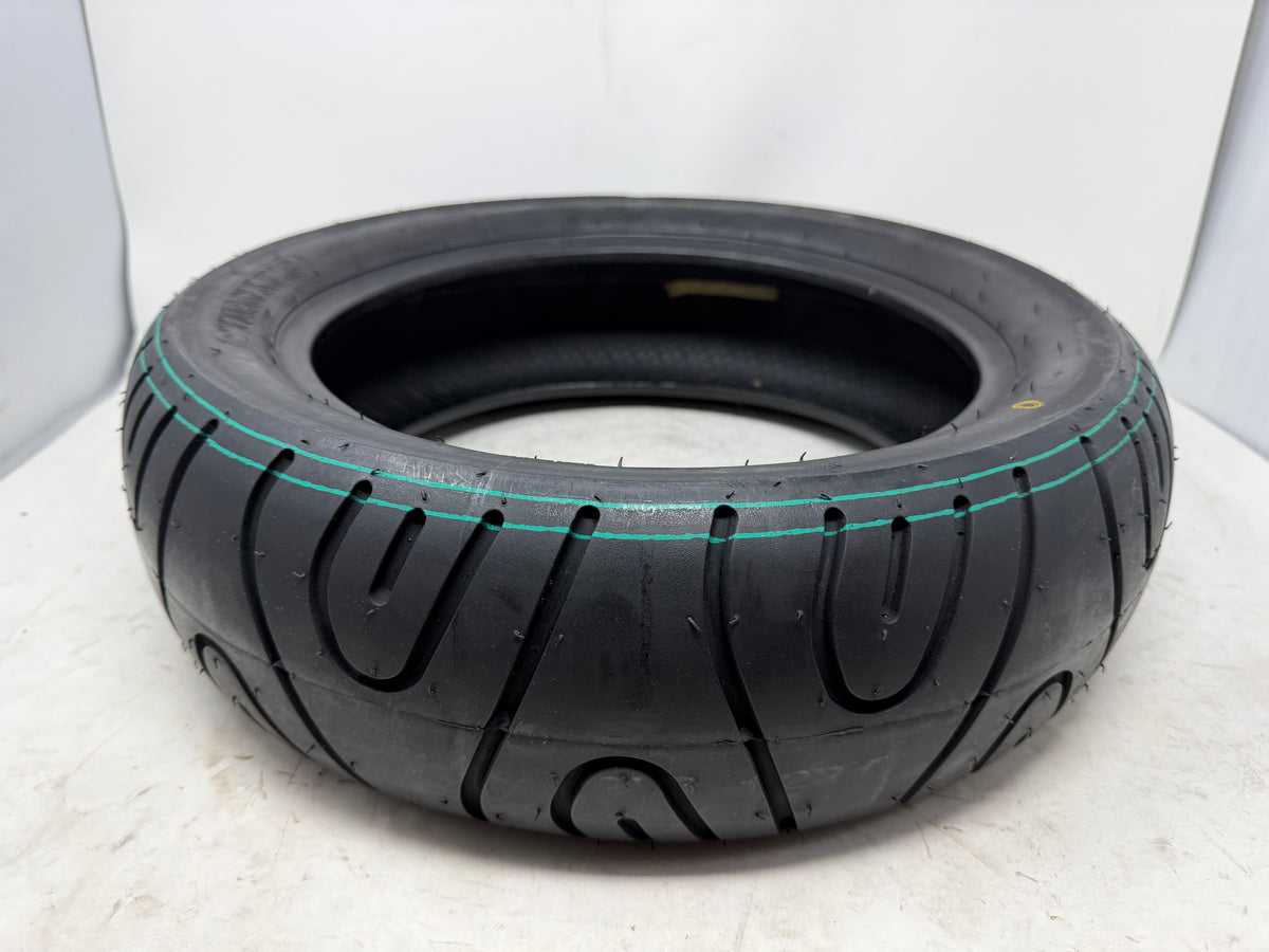 130/70-12 motorcycle tire, angled view showing tread pattern