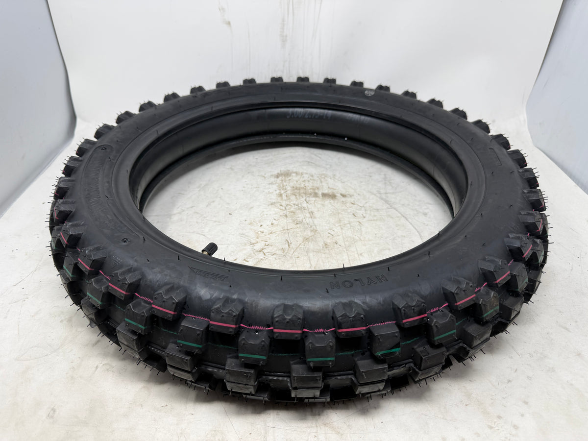 90/100-14 motorcycle tire, angled view showing tread pattern, with inner tube and valve stem visible
