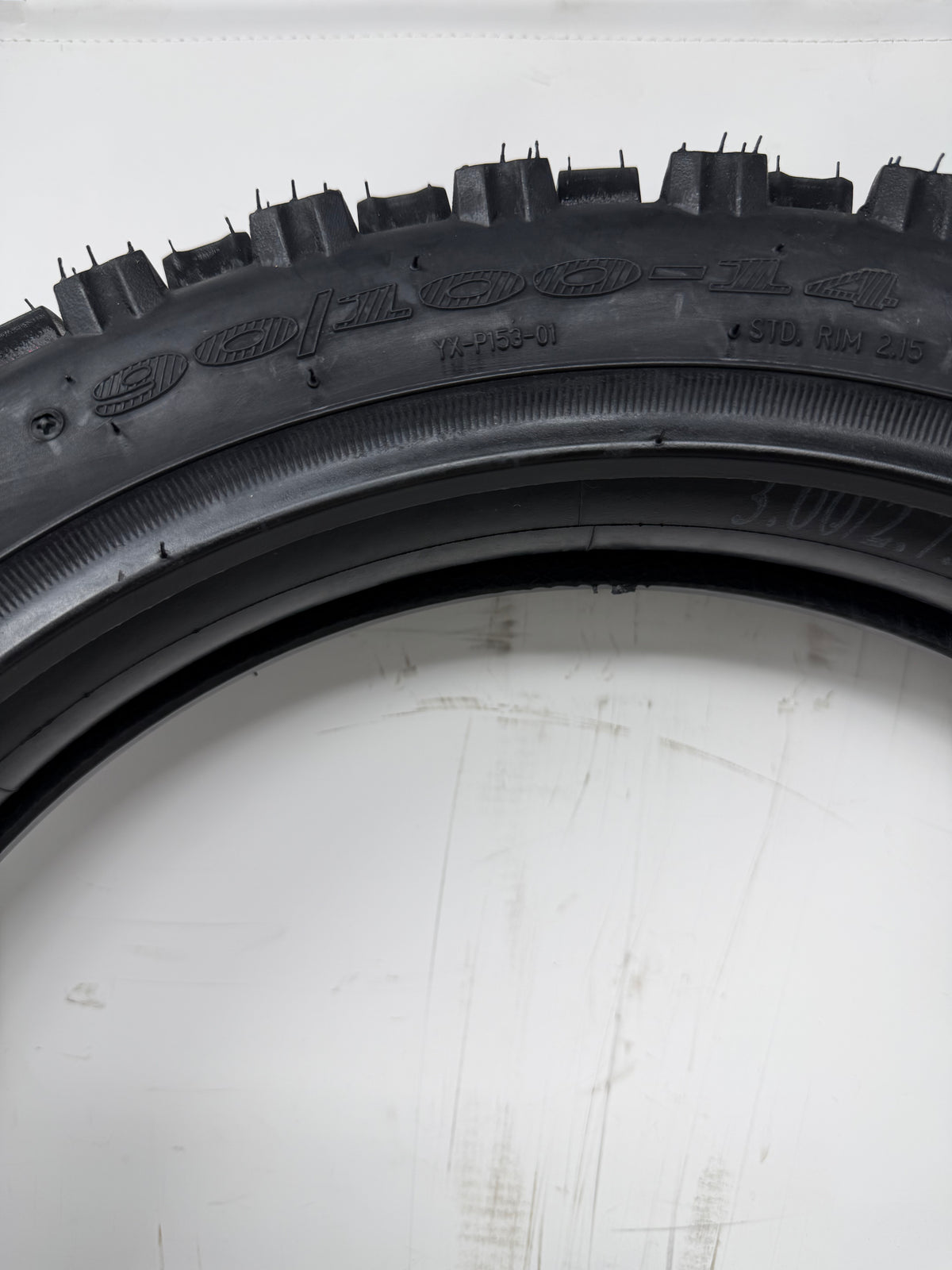 90/100-14 motorcycle tire, close-up of size and molded sidewall markings