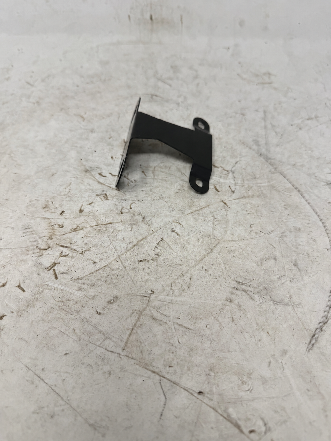 Black front license plate bracket for Sportster 250cc DF250RTG showing folded mounting tabs, side view