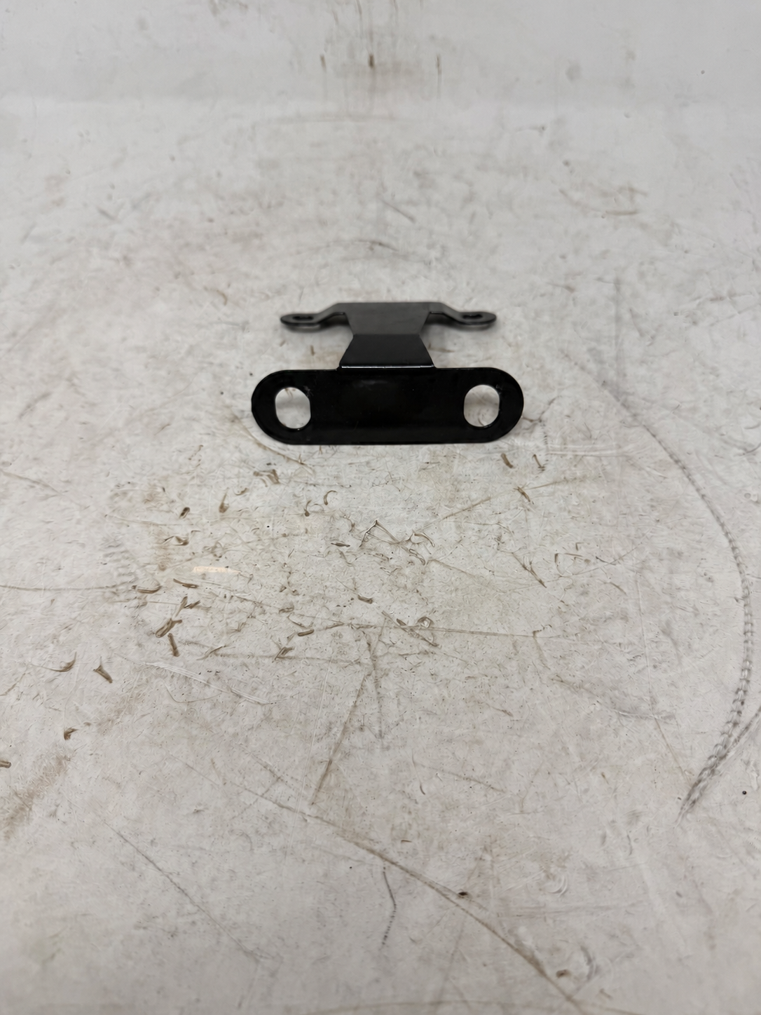 Sportster 250cc DF250RTG black front license plate bracket with two elongated mounting slots, front view