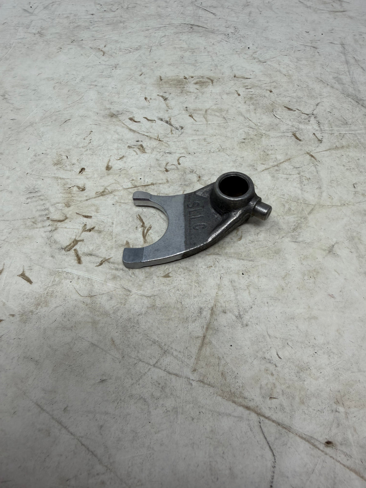 Alternate angle of the DF250RTG Sportster 250cc center transmission shift fork showing its mainshaft fork arms and guide bore