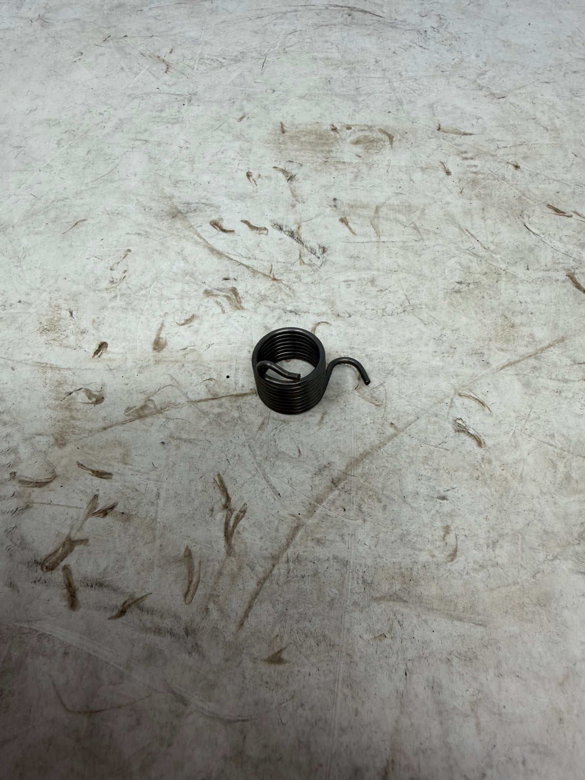 DF250RTG Venom Sportster 250cc clutch controlling arm return spring with coiled body and projecting ends, part 22427-I006-0000
