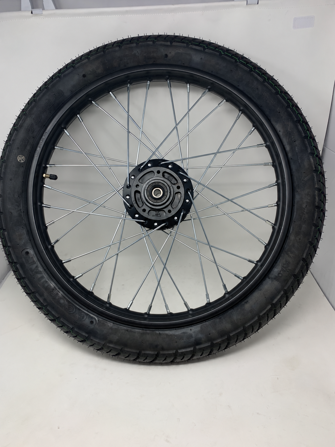 DF250RTG Venom Sportster 250cc front 2.75-18 tire on black spoked rim, disc mounting side, rim part 02040351