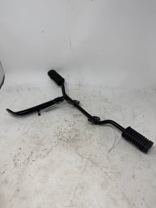 DF250RTG Sportster 250cc kickstand 02011853 shown mounted on a footrest bar; stand, bolt and spring only, footrests not included