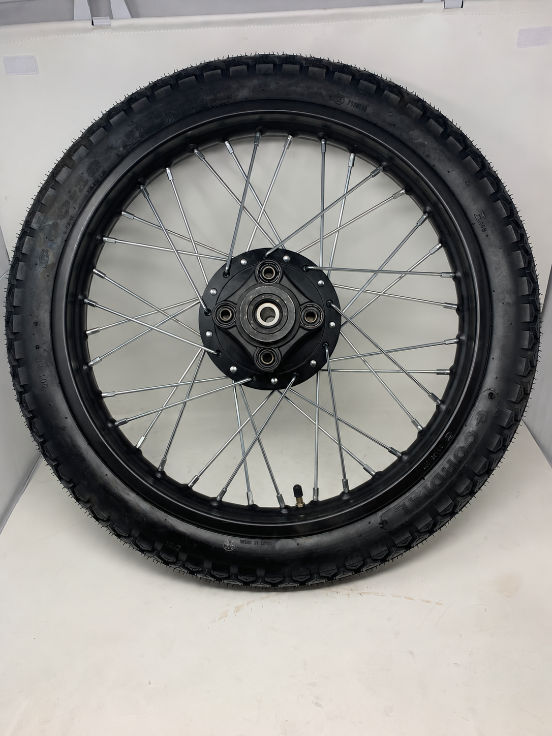 DF250RTG Venom Sportster 250cc rear 3.00-18 tire on black spoked rim, drive side, rim part 02040352
