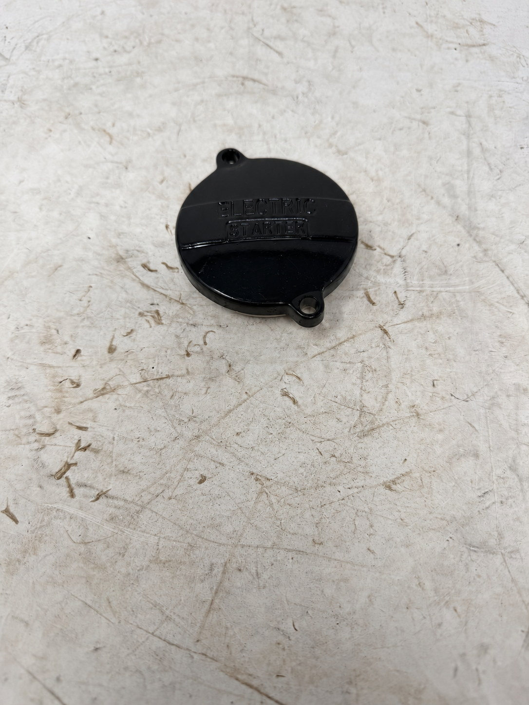 Black starter reduction gear cover for DF250RTG Sportster 250cc motorcycle, outside view with Electric Starter lettering