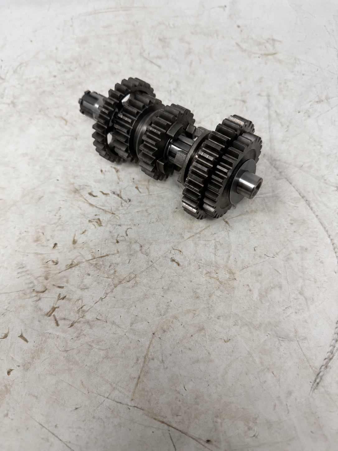 Transmission countershaft gear assembly for DF250RTG Sportster 250cc motorcycle, angled view of gears and shaft