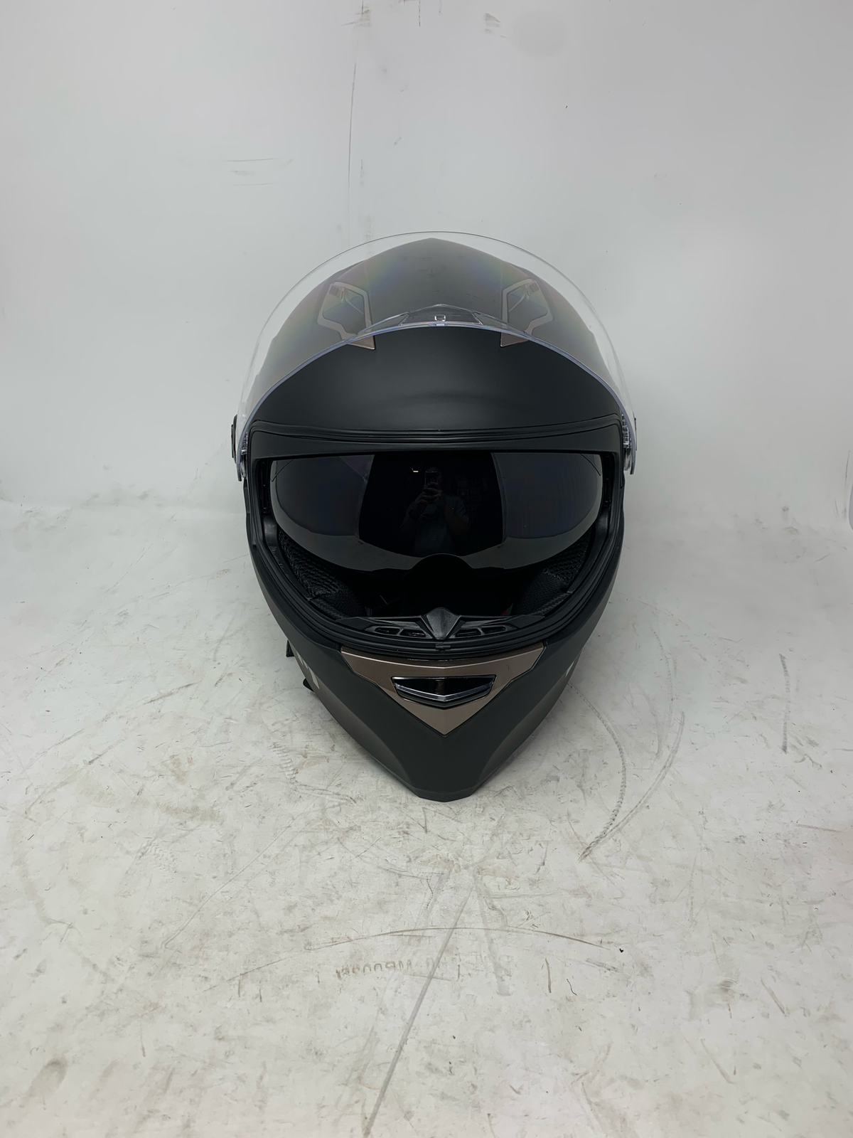 Black dual visor motorcycle helmet with clear shield raised and internal tinted sun visor lowered